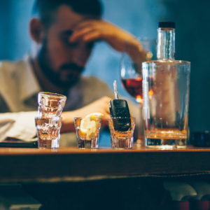 alcoholic drinks and broods with his car keys in view