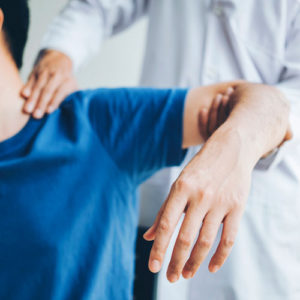 a young child gets his neck and arm adjusted