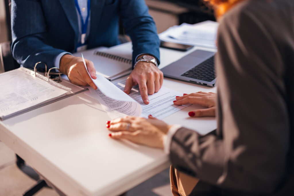 A personal injury attorney helps a client work through paperwork.