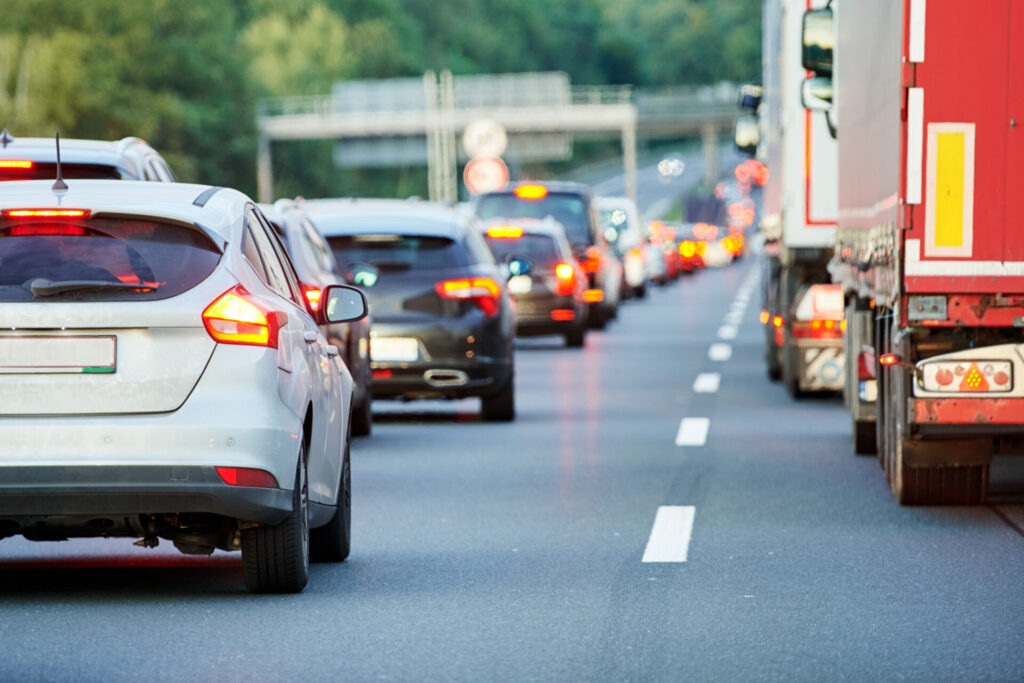 traffic jam on the interstate. Cars and trucks in bumper-to-bumper traffic.